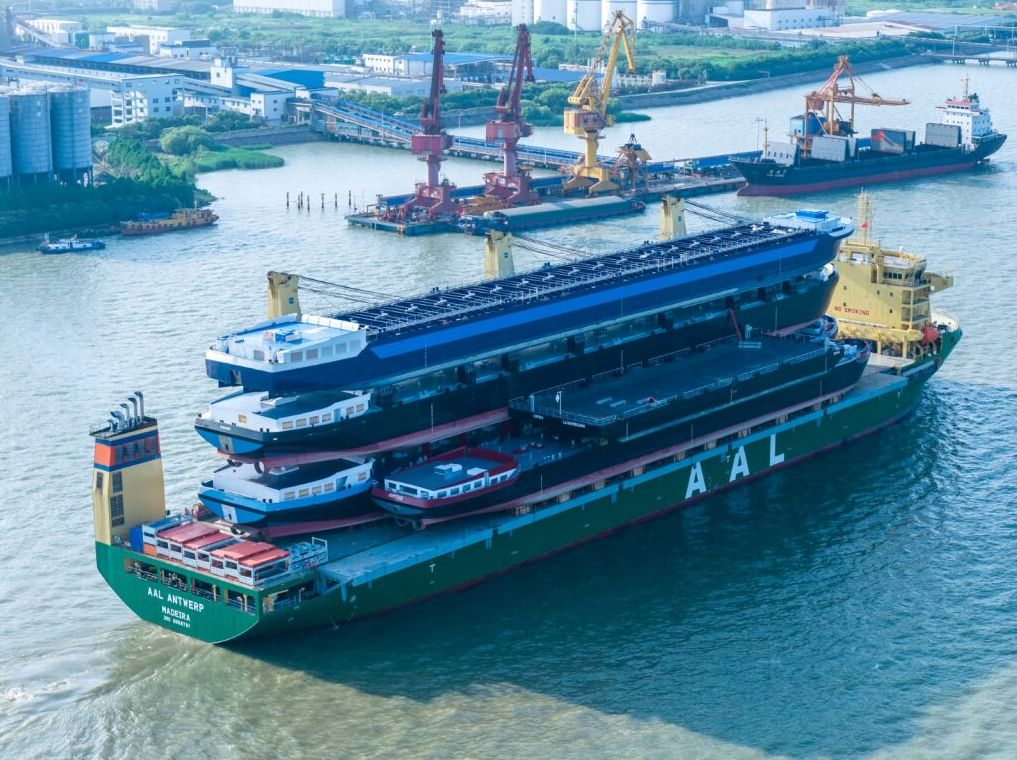 AAL Shipping's multipurpose heavy lift ship carrying multiple stacked barges from China to Europe.