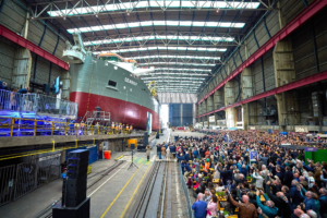 Trailing suction hopper dredger Seaway being launched at Royal IHC shipyard with large crowd attending the ceremony.