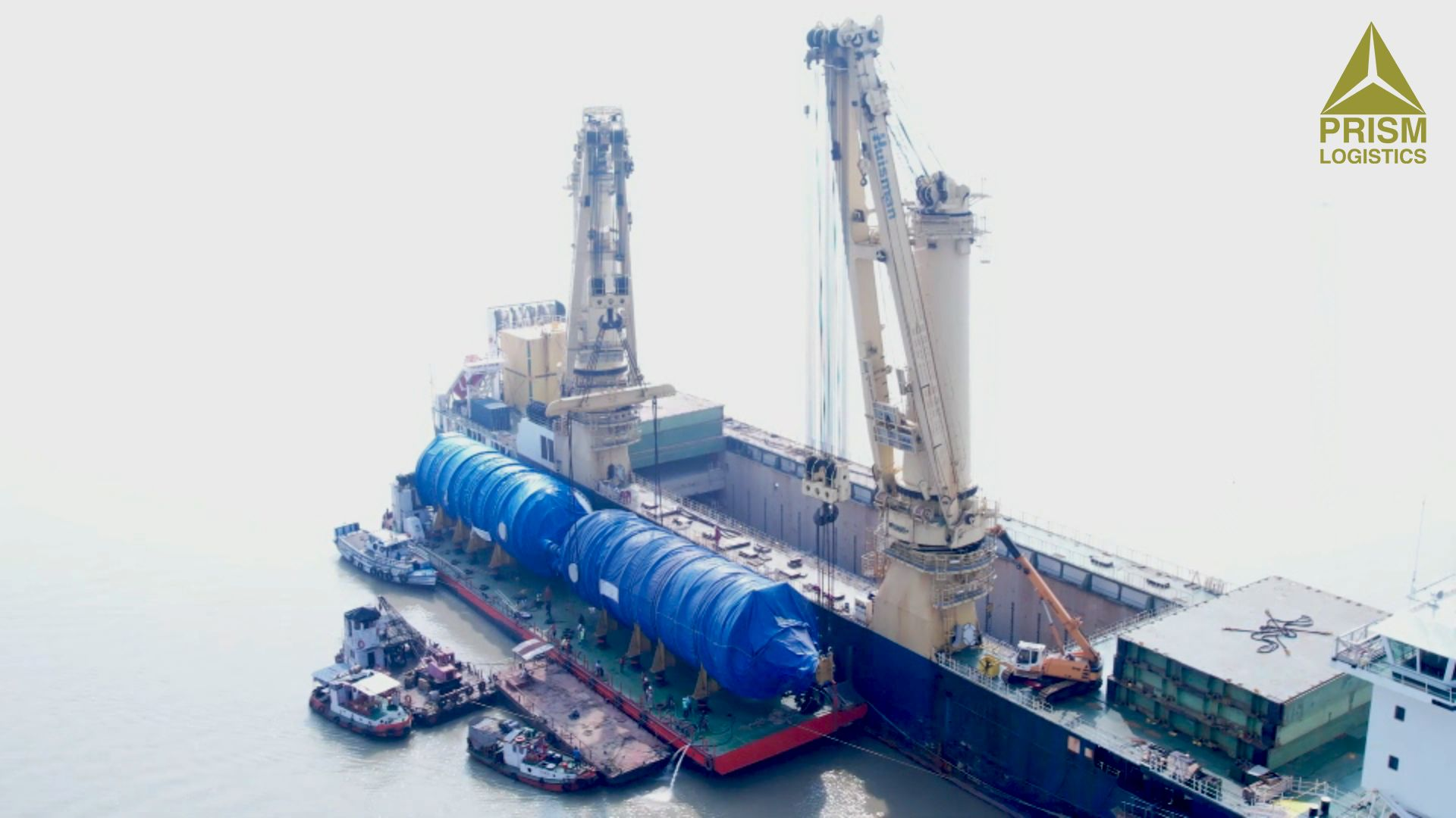 Heavy-lift operation transferring a coke chamber from vessel to barge in India